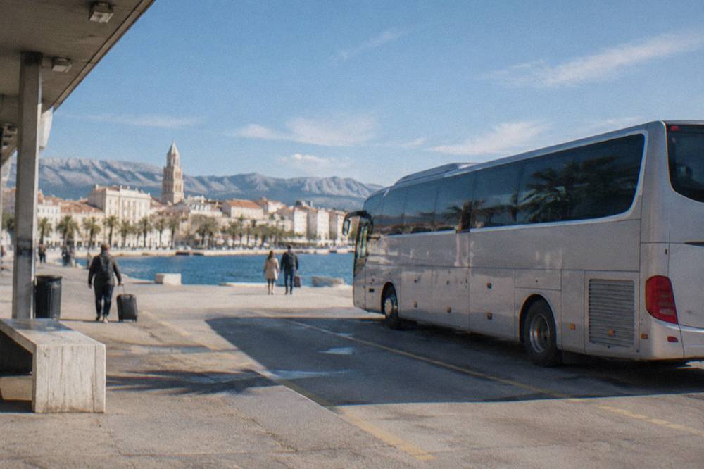 A long-distance coach parked at a bus station near the waterfront in Split