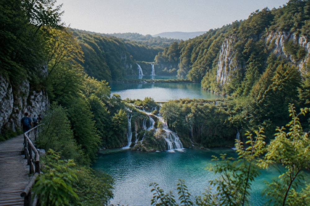 A chain of turquoise lakes stepping down a forested valley under a clear sky