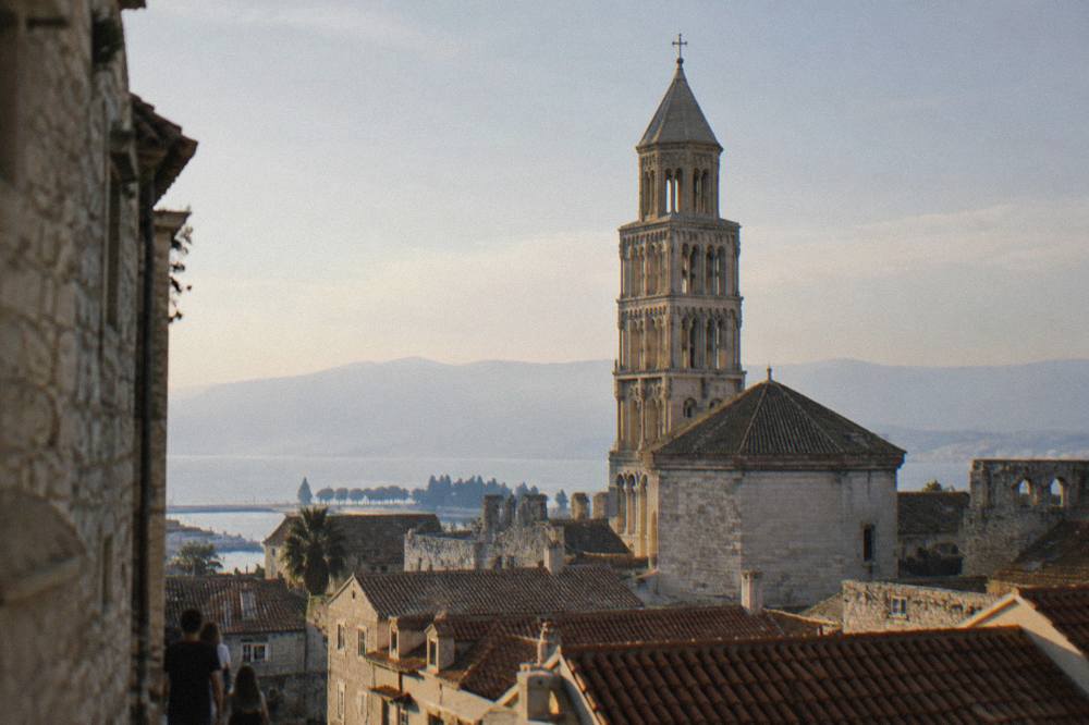 The bell tower of the Cathedral of St Domnius rising above the stone roofs of Diocletian's Palace in Split