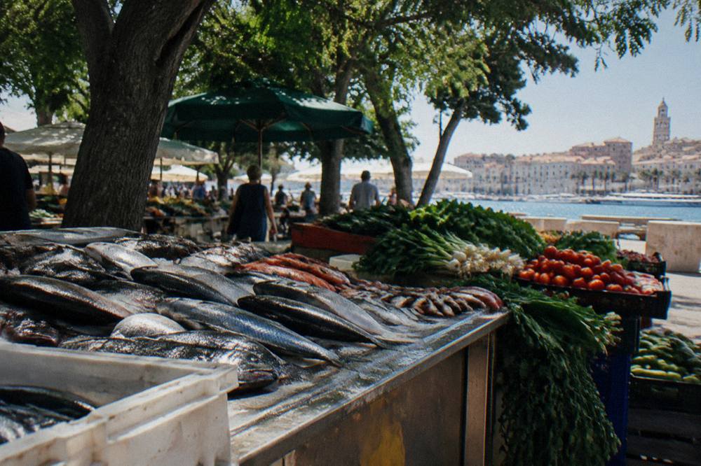Fresh fish and vegetables displayed on a market stall in Split in the morning