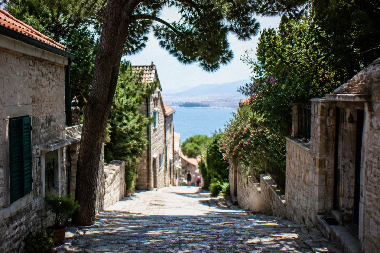 Narrow stone street with old houses in a quiet Split neighbourhood under the Marjan hill