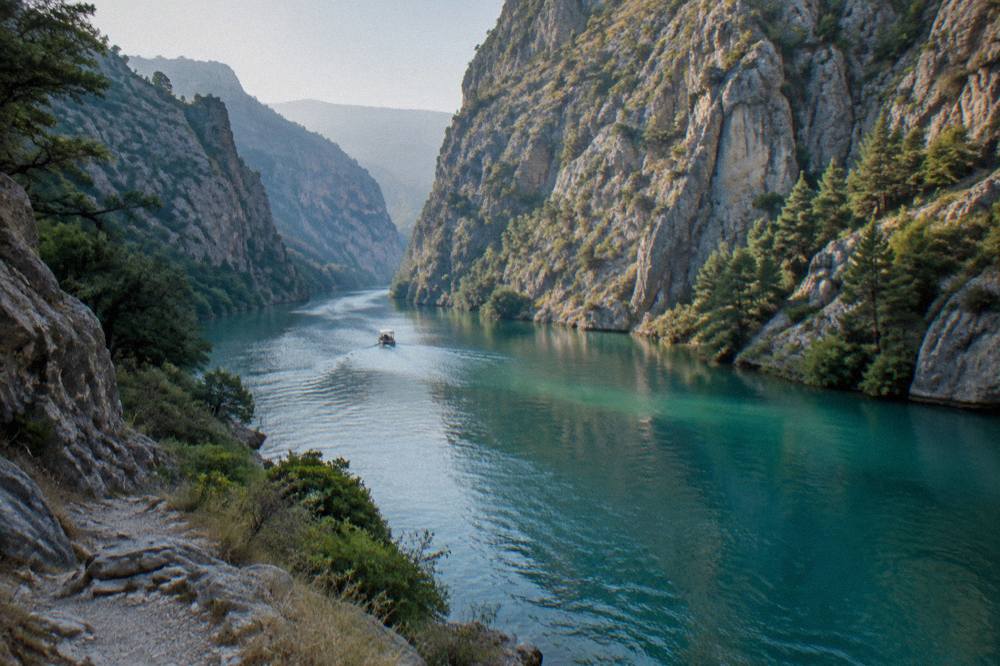 Turquoise water of the Cetina river canyon winding between high rocky cliffs near Omiš