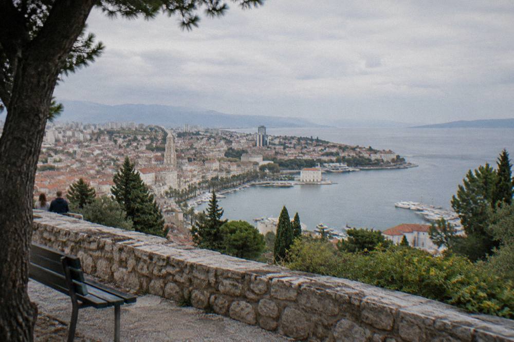 A hilltop terrace on Marjan looking over terracotta roofs and the sea in early autumn light