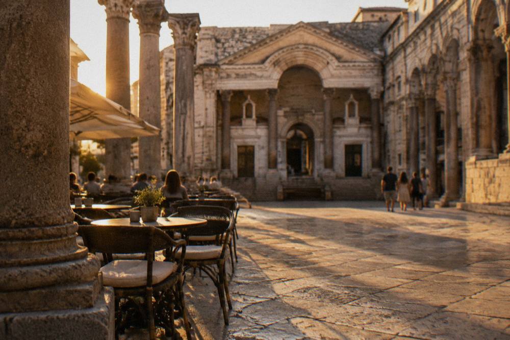 Peristyle square in Diocletian's Palace with Roman columns and café seating
