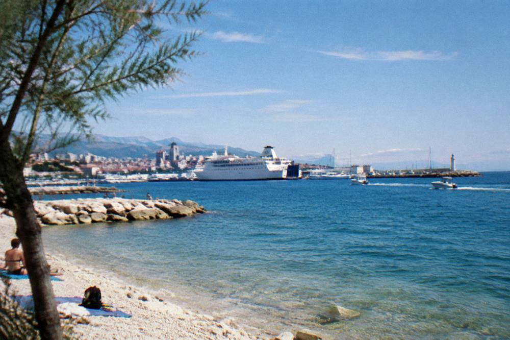 A car ferry and small boats in the passenger port of Split seen from the shore
