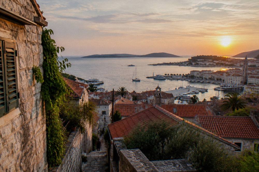 View over the red roofs of Veli Varos toward Split harbour and islands at golden hour