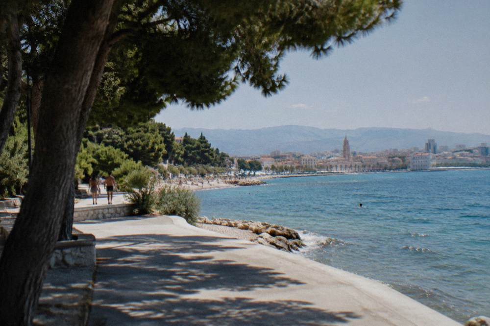 Seaside promenade curving from Žnjan toward the Bačvice bay and the Split skyline