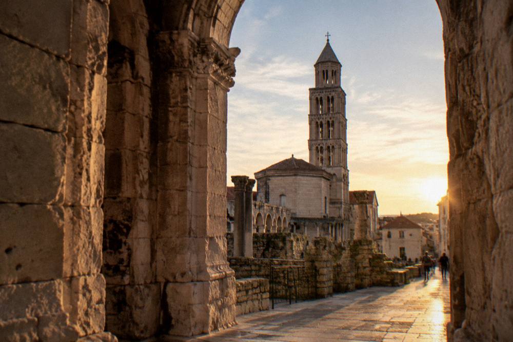 The bell tower and stone buildings of the cathedral complex seen from inside Diocletian's Palace in Split