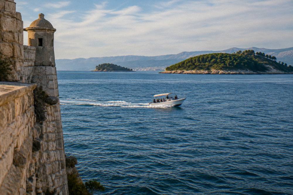 A speedboat crossing open blue water between islands near Split with passengers on board