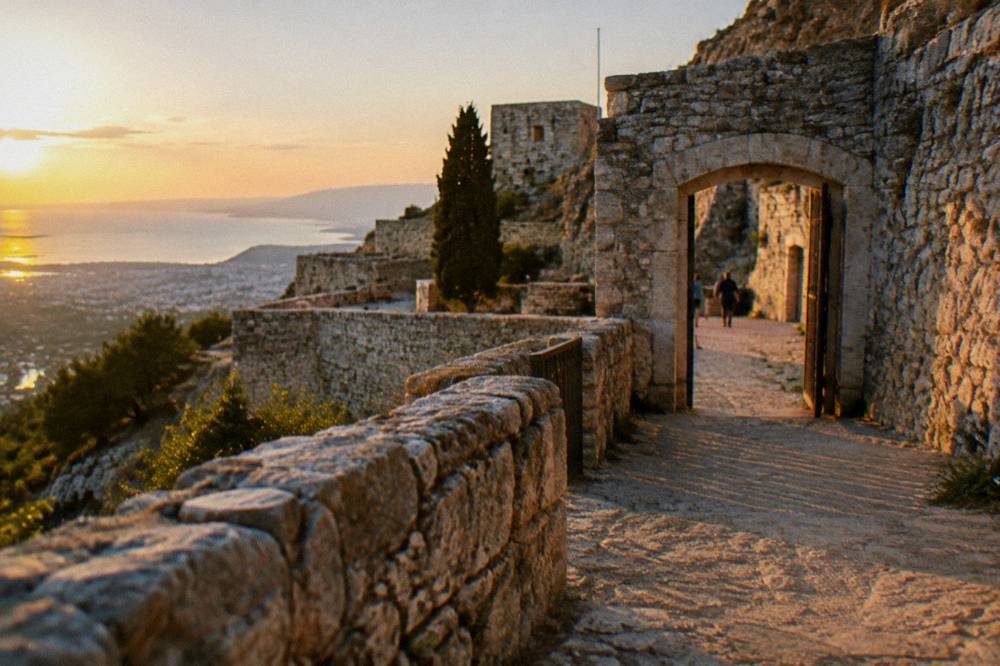 Terraced stone walls and an open gateway inside a hilltop fortress