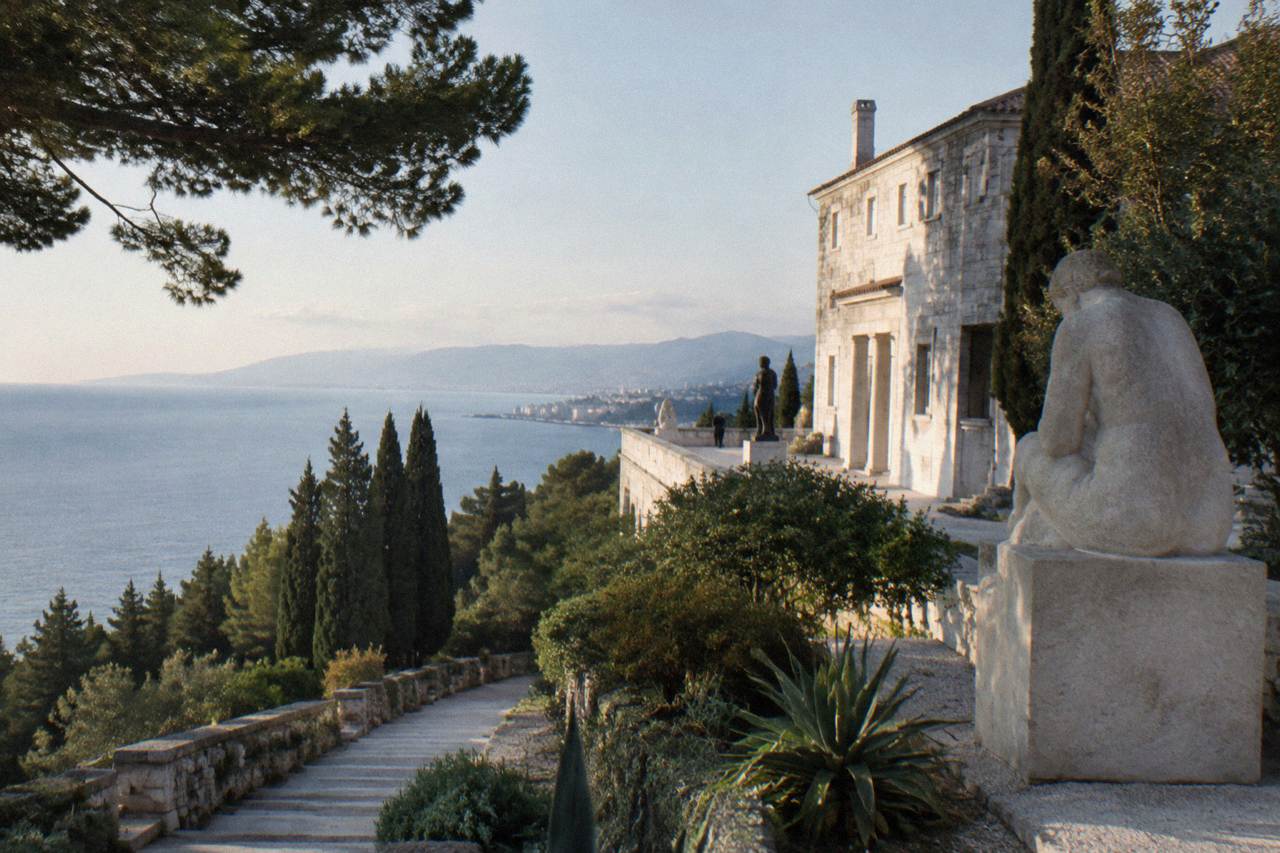 A white stone villa on a wooded slope above the Adriatic sea near Split
