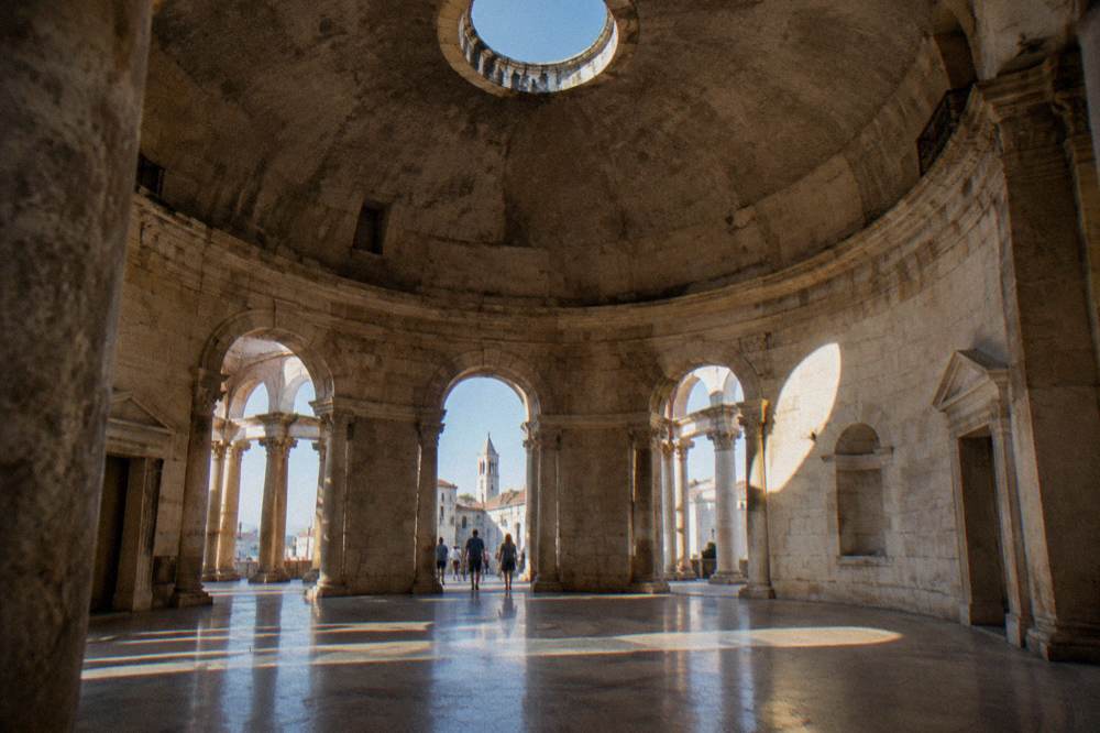 The round stone interior of the Vestibule with a circular opening in its domed ceiling