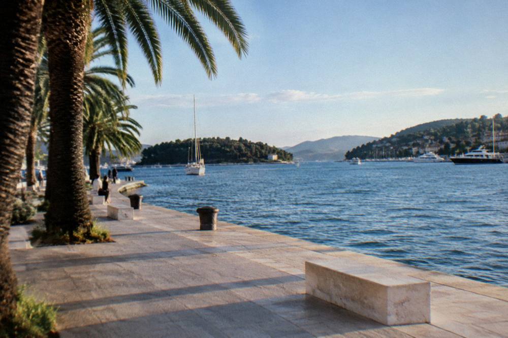 View from the promenade across the harbour toward wooded hills and islands