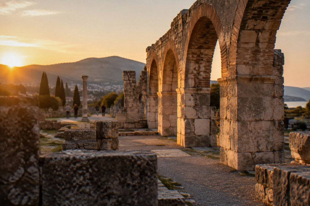 Sunlight falling across remaining arches of the Roman bath building at Salona