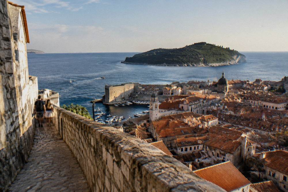View from Dubrovnik walls over red rooftops to the island of Lokrum