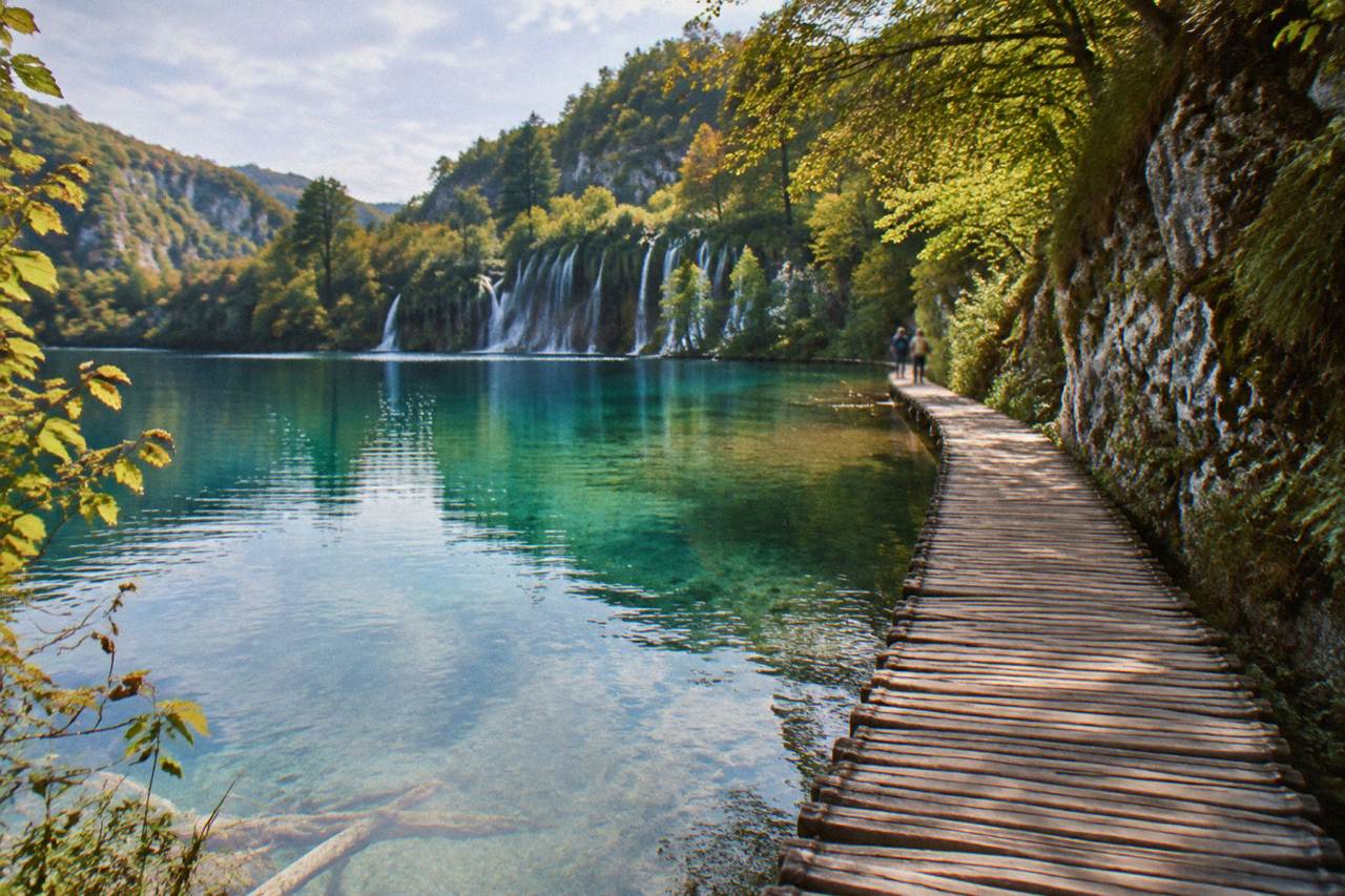 Wooden walkway crossing a turquoise lake at Plitvice Lakes National Park