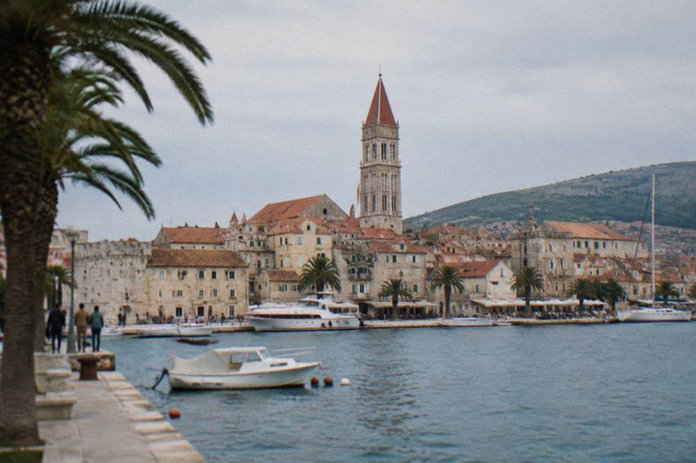 Cathedral bell tower rising above red rooftops of an island old town