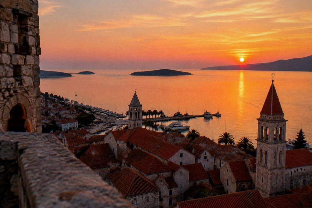 Evening view over rooftops and the sea from an old tower