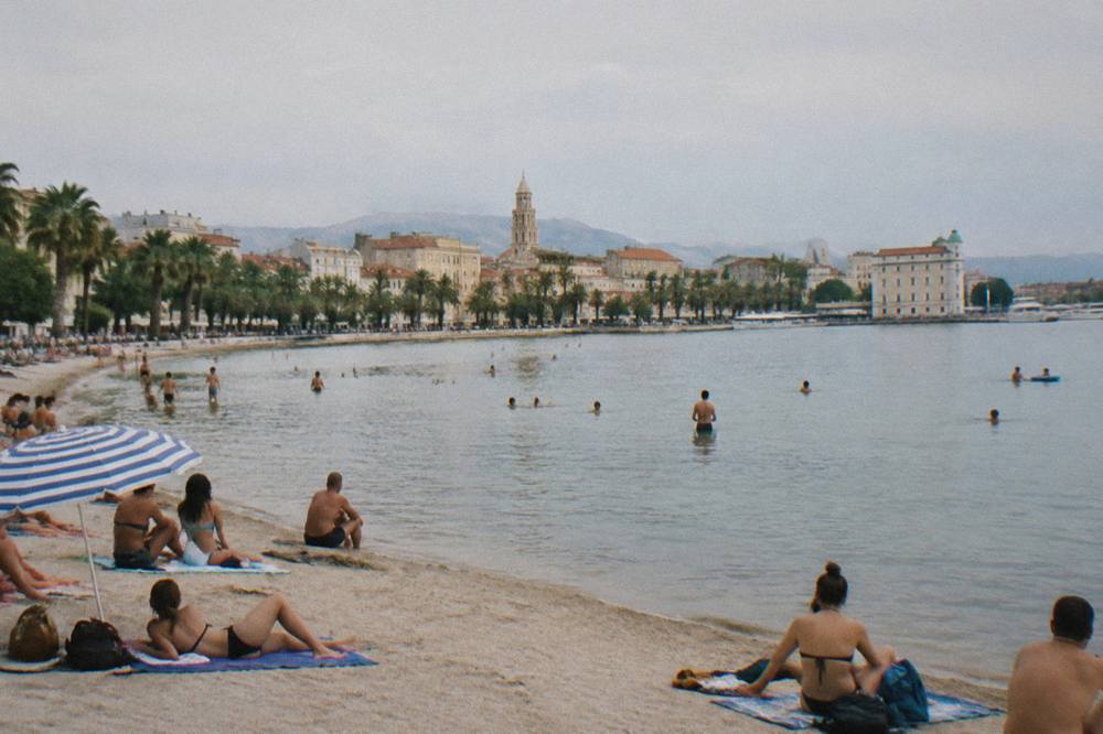Sunbathers and swimmers on the sandy beach at Bačvice bay near the city centre