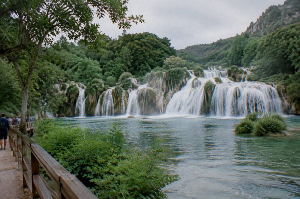 Waterfalls spilling over travertine barriers in a green river canyon in Dalmatia