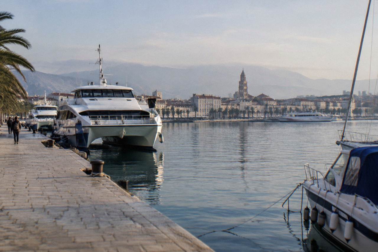 Ferry port of Split with catamarans and boats moored along the waterfront promenade