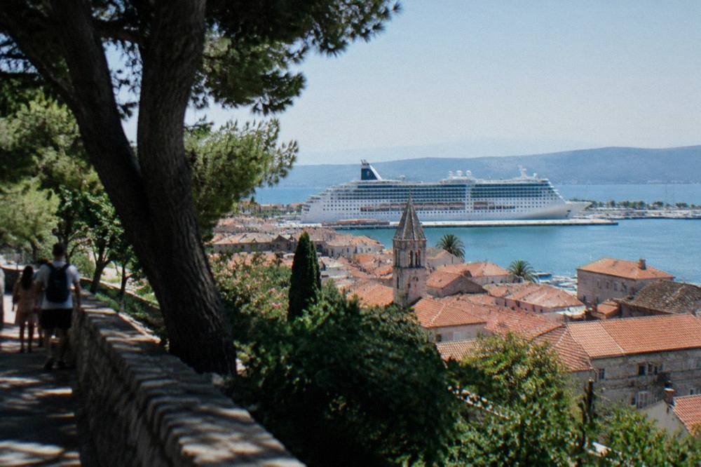 Cruise ship berthed at Split port seen across rooftops of the Old Town