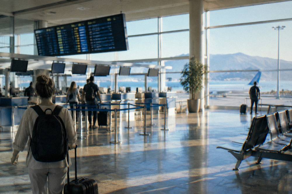 Check-in desks and departure boards inside a bright airport terminal in Dalmatia