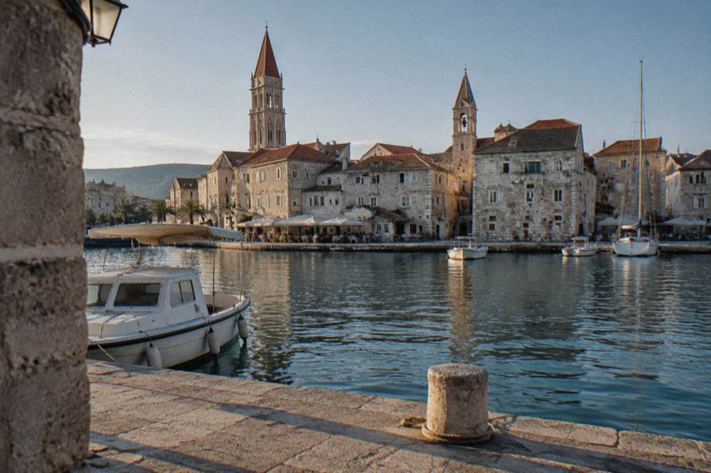 Waterfront stone houses of Trogir old town seen across a small harbour