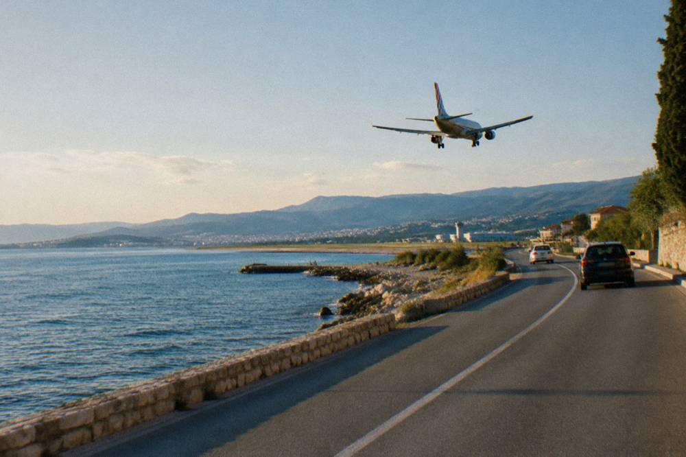 Coastal road winding along the Kastela shoreline with the sea on one side