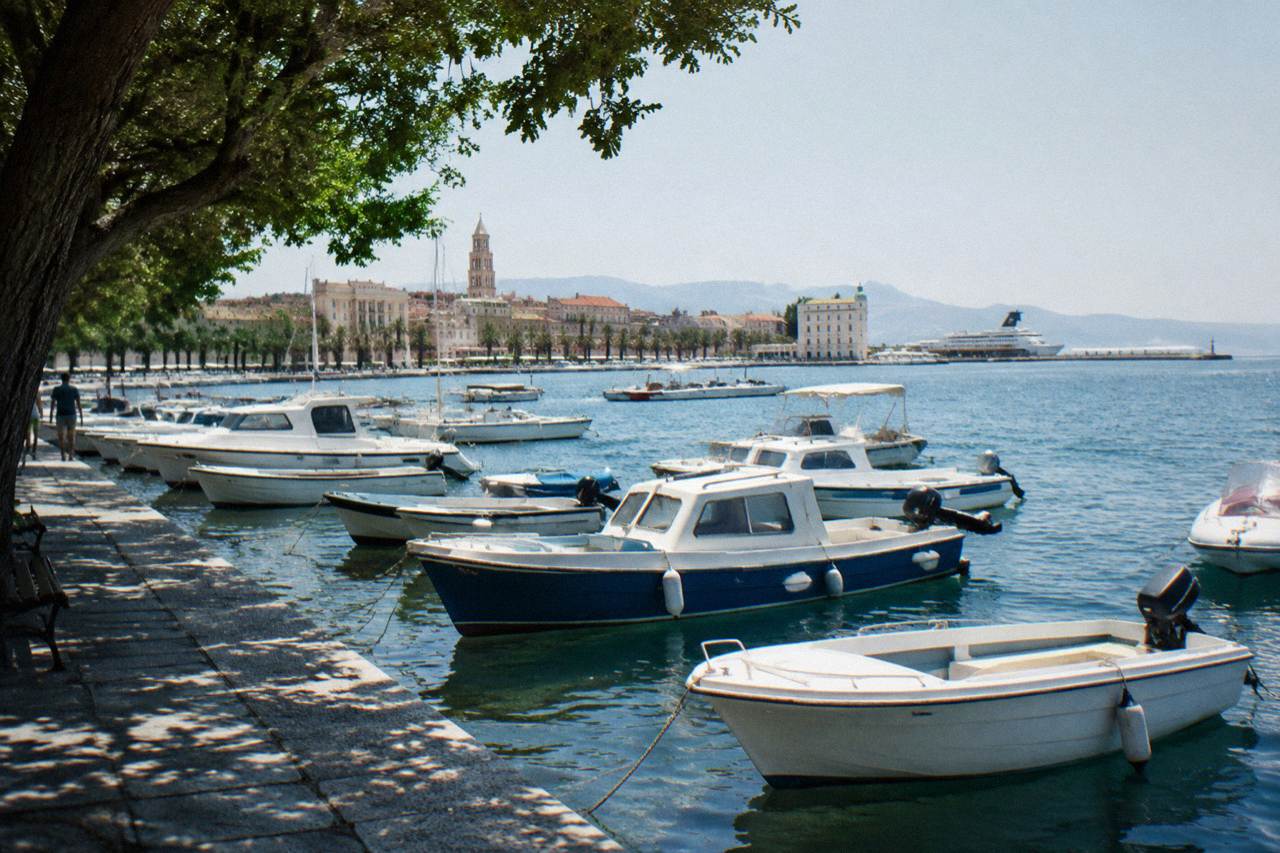 Small boats moored in a marina near the Split waterfront with the Adriatic sea behind them