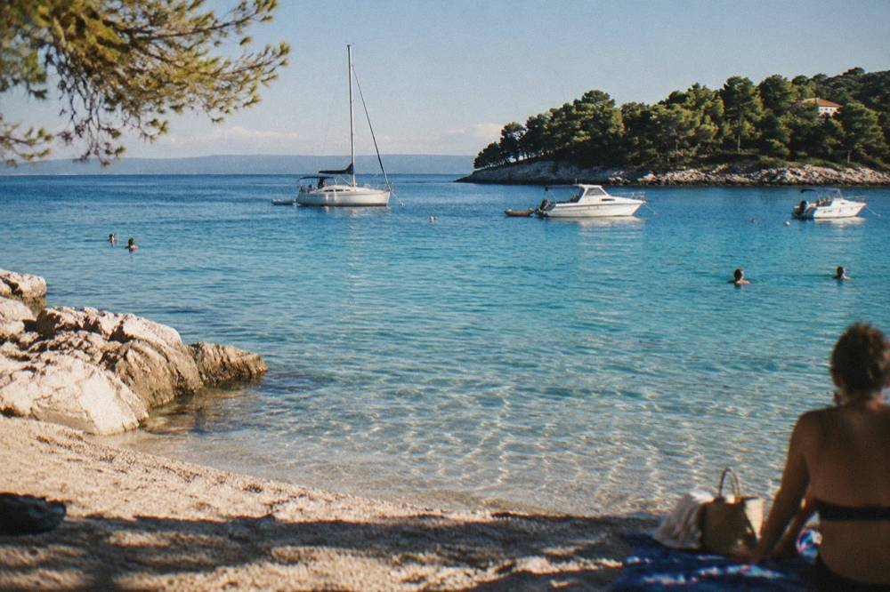 Turquoise shallow water at a Dalmatian island cove with a few anchored boats