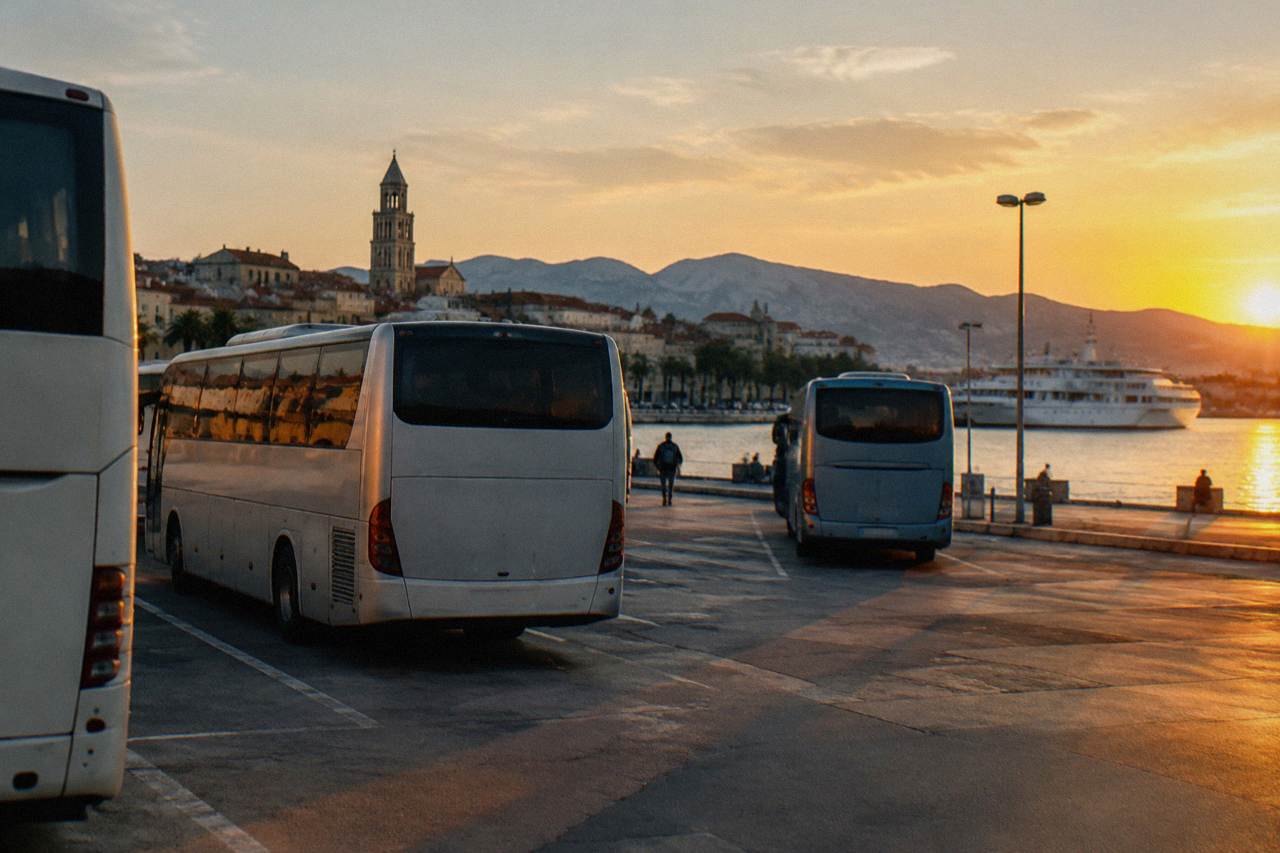 Buses parked at the Split bus station with the Adriatic waterfront and ferry port behind them