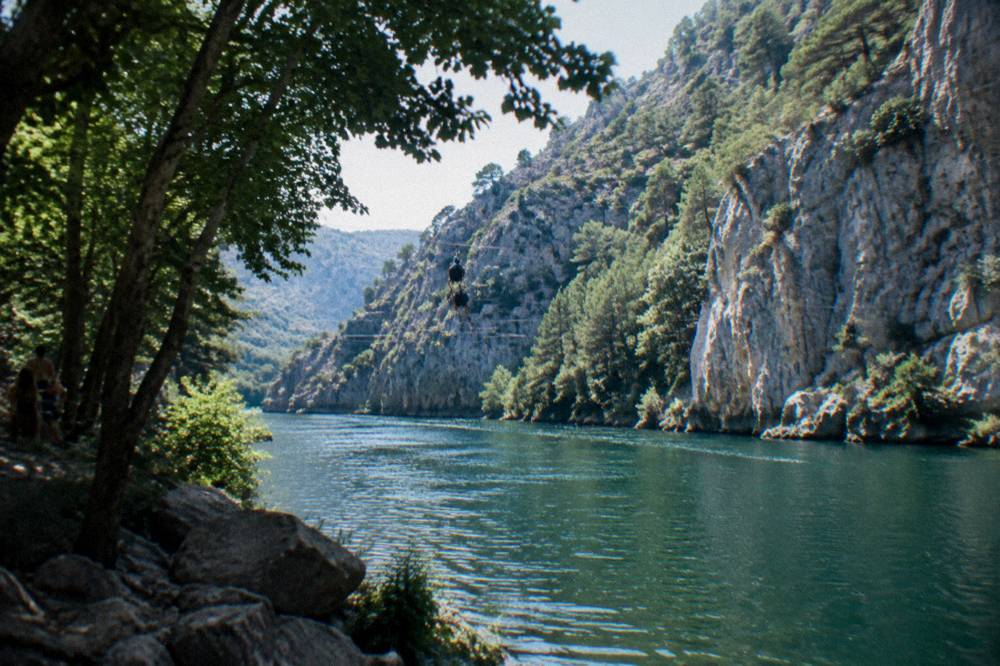 Zipline cables stretched across the green Cetina river canyon near Omiš