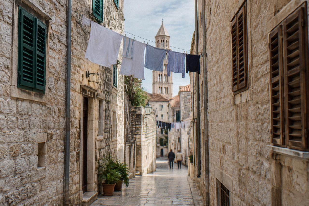 A stone alley in Split Old Town with laundry strung between warm-toned buildings