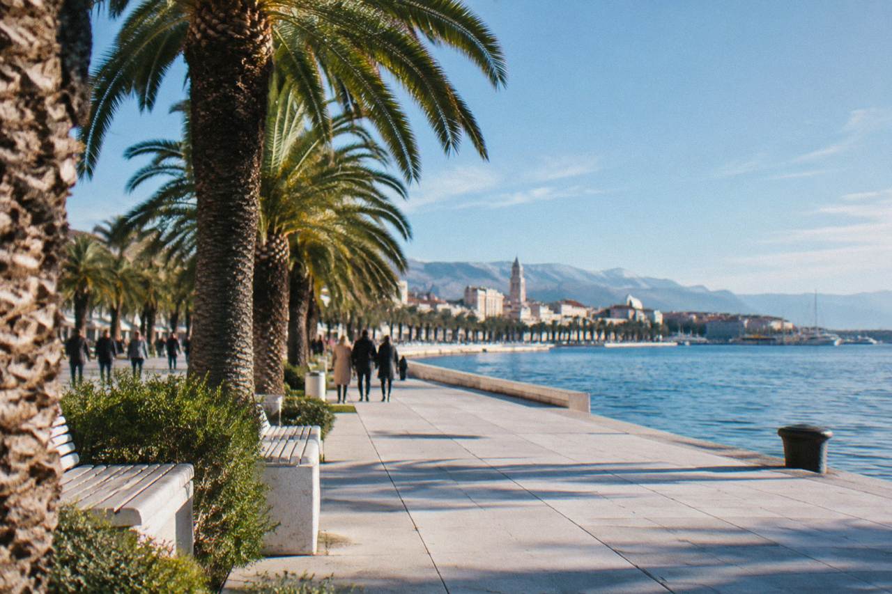 The seafront promenade in Split on a calm winter day with palm trees and the Adriatic in the background