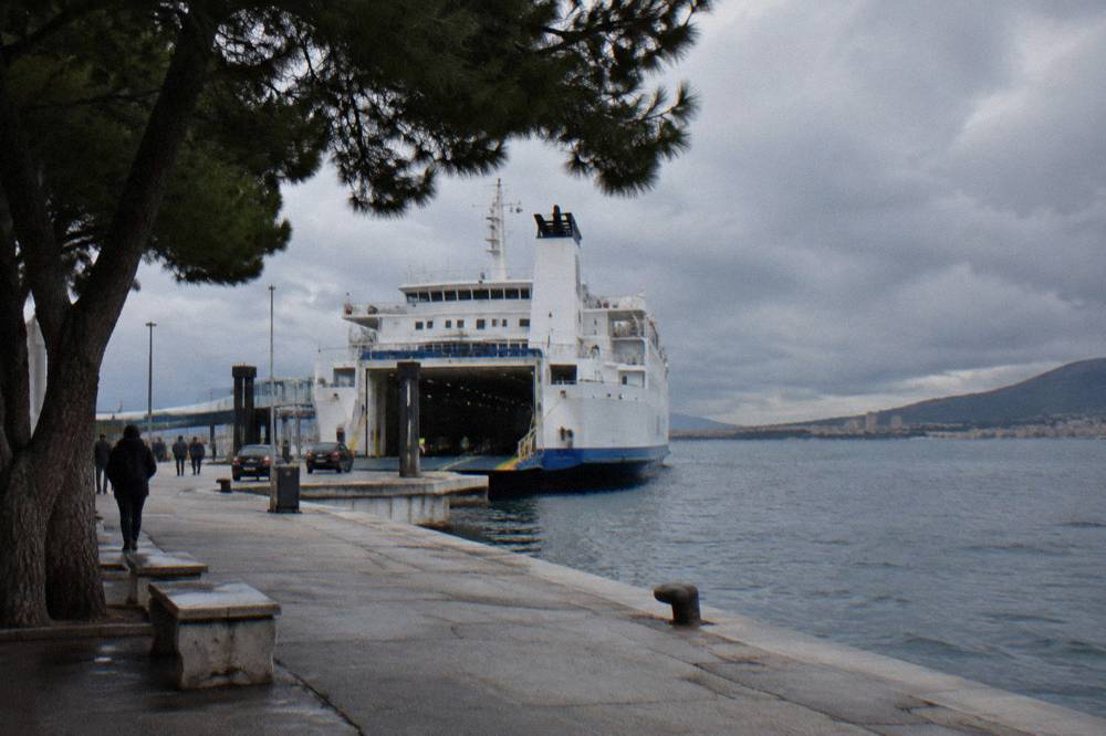 A large car ferry at the Split ferry port in winter with grey sea and clouds