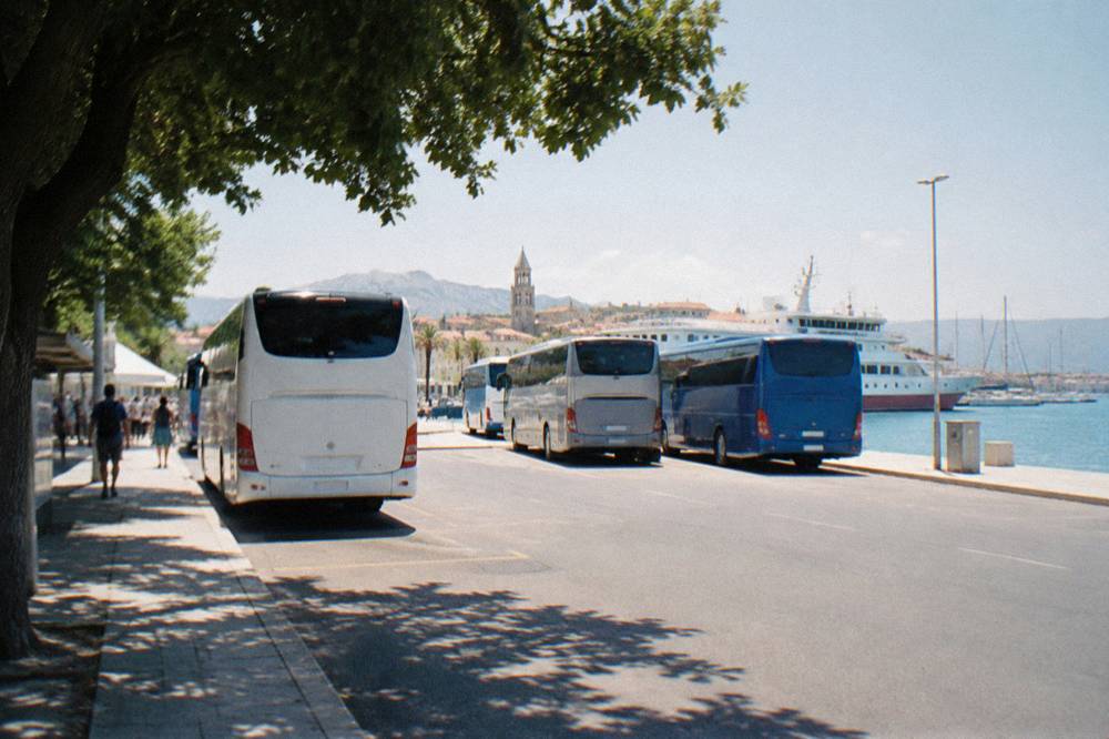 Buses parked at the Split main bus station next to the ferry terminal and moored ships
