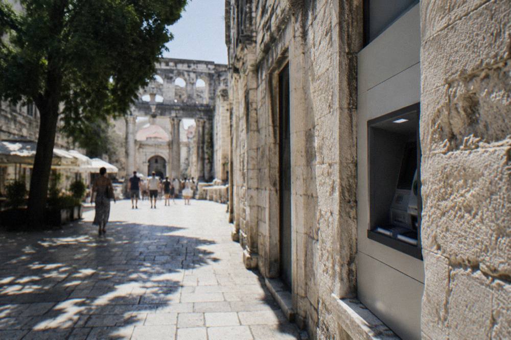A bank ATM set into a wall on a shopping street in Split