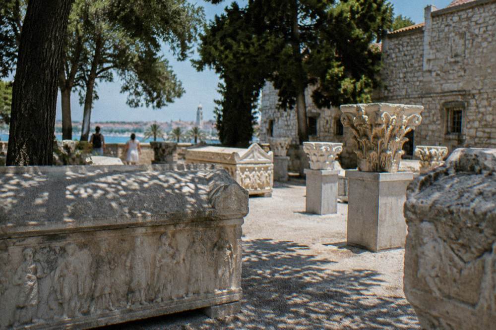 Stone Roman sarcophagi and capitals arranged in a museum lapidarium