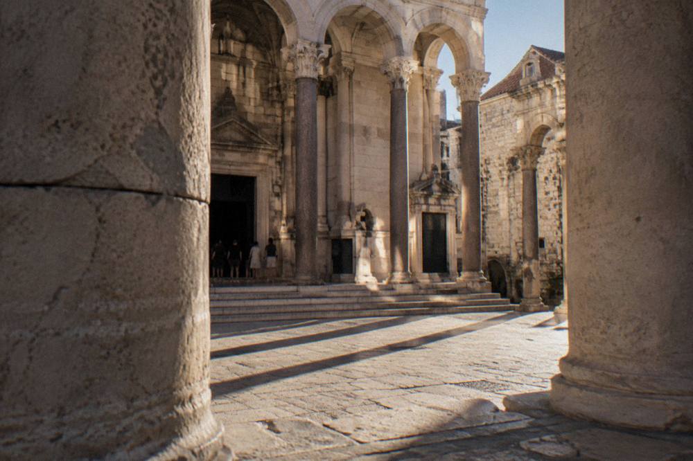 The sunlit Peristyle of Diocletian's Palace framed by stone columns