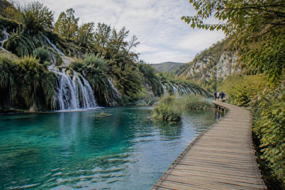 Wooden walkway over turquoise lakes at Plitvice Lakes National Park