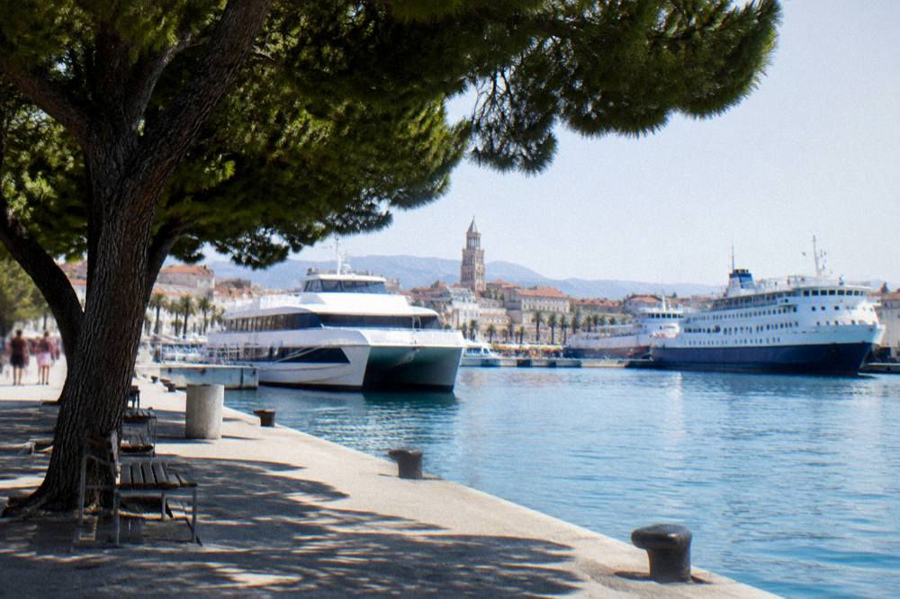 Catamaran and ferries moored at the Split passenger port in morning light