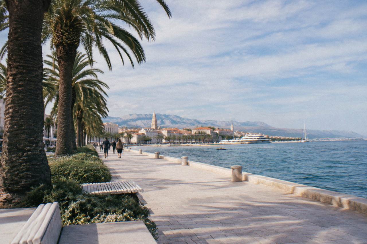 The seafront promenade in Split with palm trees and the Adriatic horizon at midday