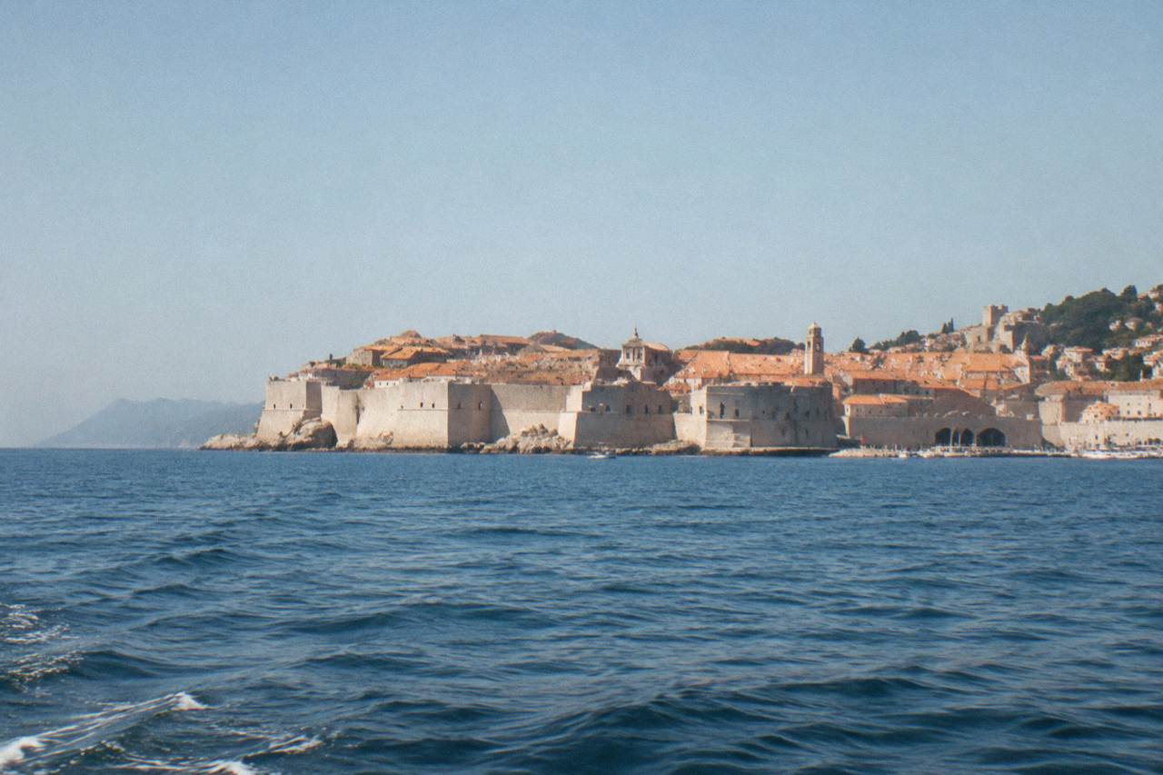The walled old town of Dubrovnik seen from the sea on a bright afternoon