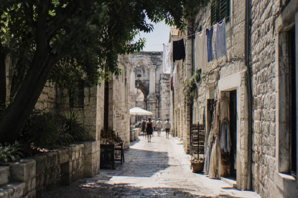 Narrow stone street inside Diocletian's Palace with laundry and small shops