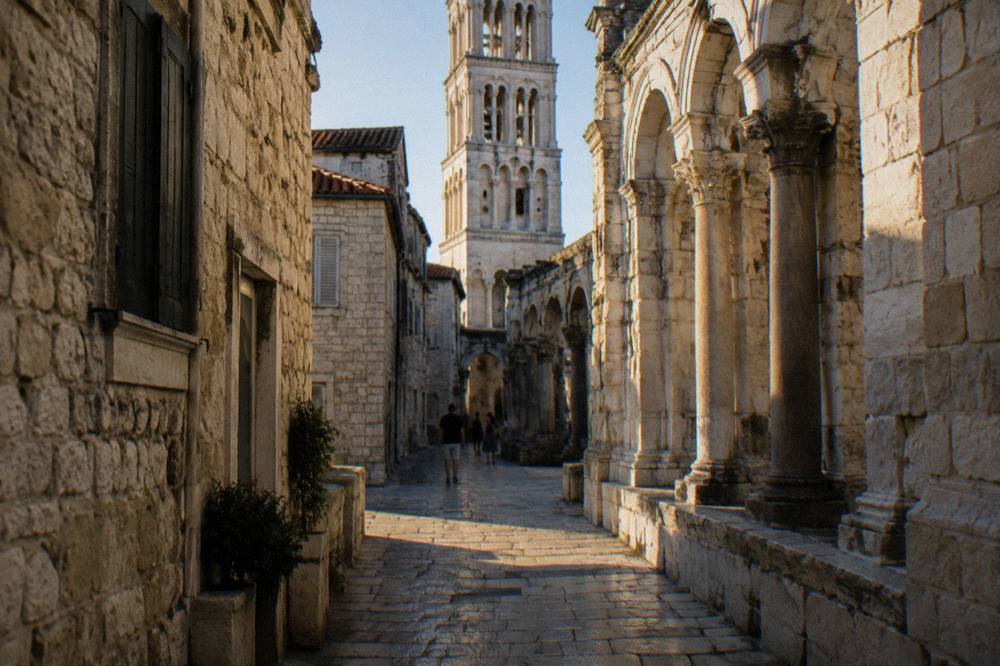 Sunlight falling on stone buildings and narrow lanes inside Diocletian's Palace in Split