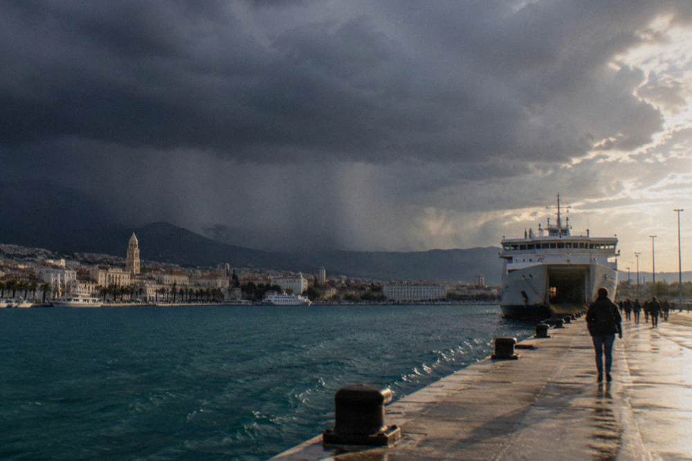 Dark clouds and rain sweeping over the rooftops and harbour of Split