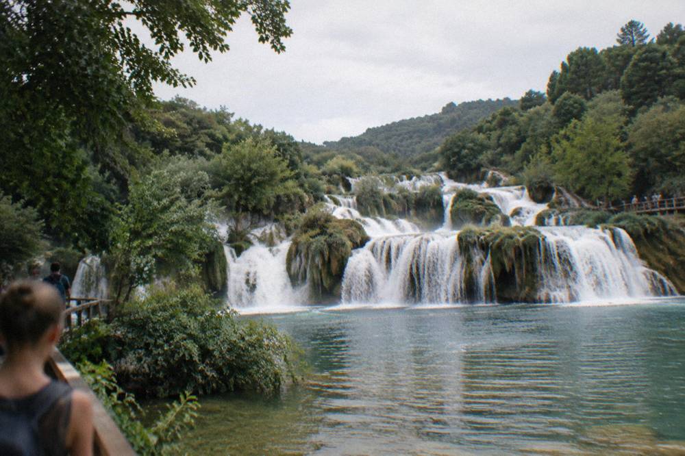 Waterfalls pouring over travertine barriers at Krka National Park on a summer day