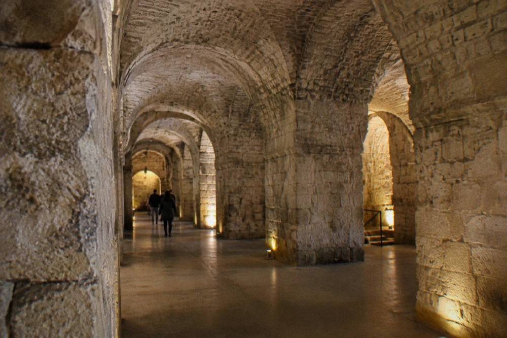 Stone vaulted interior of the Diocletian's Palace substructures lit by warm lamps
