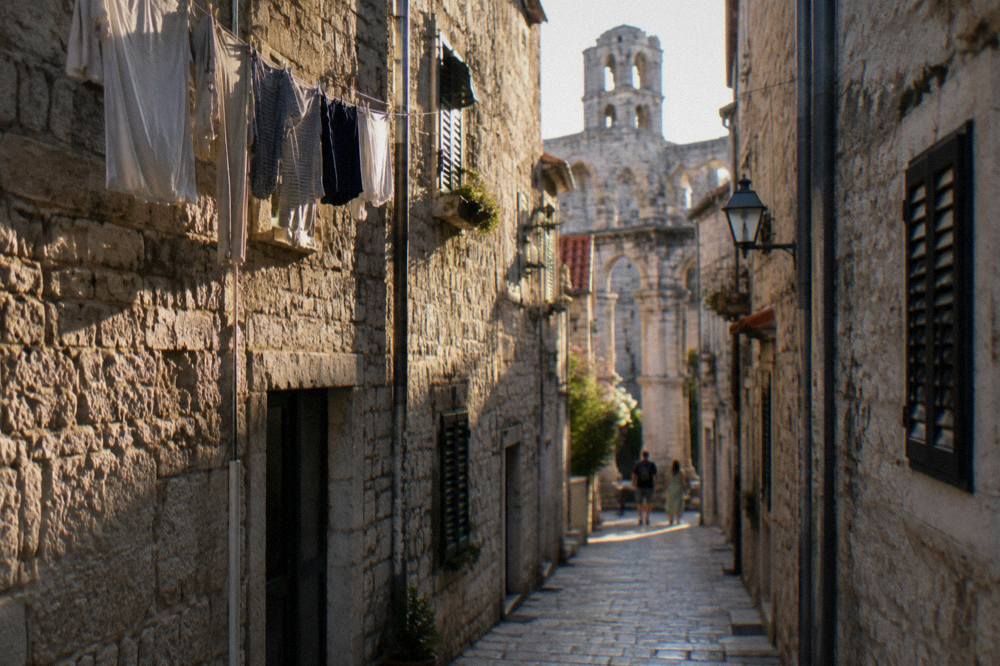 Narrow stone street with laundry and old houses in a quiet Split neighbourhood